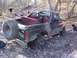 1983 Ford Bronco - This 1983 Ford Bronco is seen off-roading in a wooded area, showing signs of damage.
