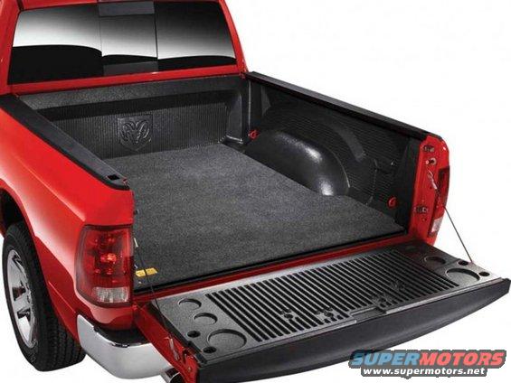 Red pickup truck bed with liner and tailgate open. Ram logo visible
