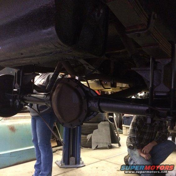 Rear axle assembly and leaf springs on a vehicle lifted for service