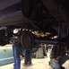 1962 Chevrolet Suburban - Underside view of a vehicle's rear axle and suspension system during maintenance.