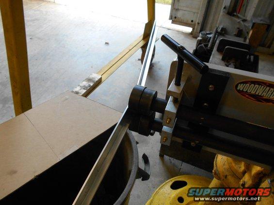 Metal roller machine with Woodward logo