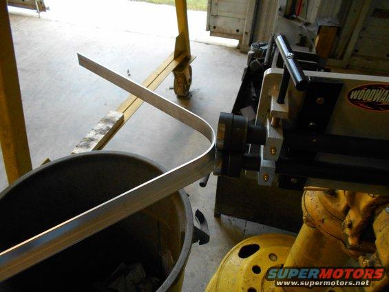 Woodward metal roller bending aluminum stock over a bucket