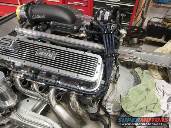 Chrome engine with "496" on valve cover, black spark plug wires, Edelbrock intake.
