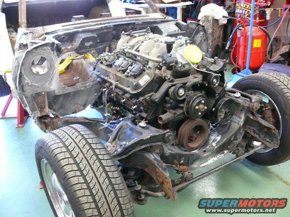 Engine and front chassis of a classic car project, with suspension and tire.