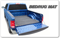 Blue pickup truck with a Bedrug mat installed in the bed