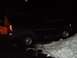 1998 Ford Expedition - A dark-colored 1997 Ford Expedition is partially stuck in a pile of snow at night.