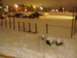 1998 Ford Expedition - A dark SUV is visible in a snowy parking lot at night, with a fence in the foreground and distant lights.