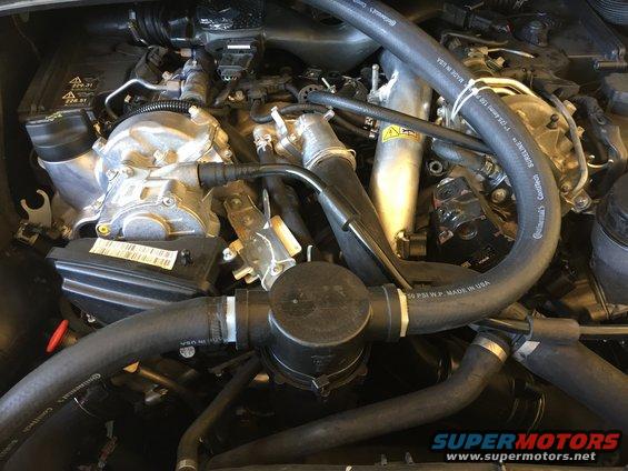 Test fitting the Spray Rig Strainer with Copper Brillo pad to help reduce amount of oil in crank case gases. The catch can hose is routed down under the car to a fitting in the exhaust system. 
