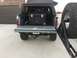1988 Ford Bronco - Rear view of a gray Ford Bronco with its tailgate open, revealing a black storage box and a spare tire mount.