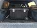 1988 Ford Bronco - Cargo area of a 1988 Ford Bronco, fitted with a large, wheeled storage container.