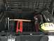 1988 Ford Bronco - Contents of a vehicle's storage box, including tools and safety equipment.