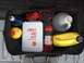 1988 Ford Bronco - A storage bag contains a first aid kit, fire extinguisher, rope, and several containers of fluids, likely for vehicle maintenance or emerge…