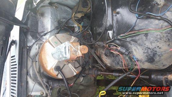 Engine bay wiring harness and brake booster assembly