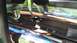 1996 Ford Bronco - A close-up view of a vehicle's chrome push bar, showing its mounting hardware and reflections.