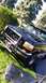 1996 Ford Bronco - A black Ford truck is parked on a grassy area, angled towards the viewer, with a prominent chrome push bar.