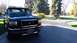 1996 Ford Bronco - This 1996 Ford Bronco features a prominent push bar and a roof rack, seen parked in a driveway.