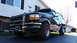 1996 Ford Bronco - Black 1996 Ford Bronco with a chrome push bar and aftermarket wheels.