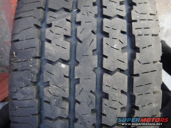 Close-up of a tire tread with a Supermotors.net watermark