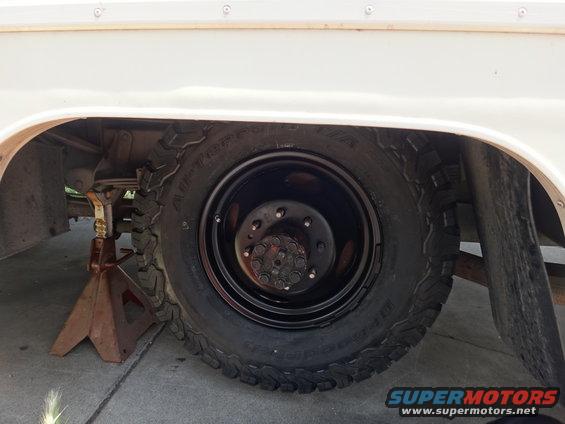 White step van wheel and tire on jack stand