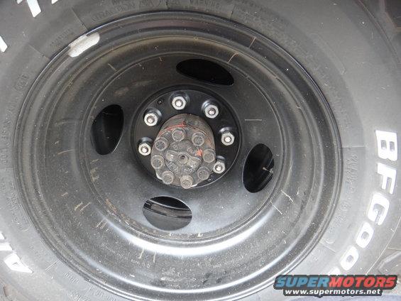 Close-up of a heavy-duty wheel hub with lug nuts and a BFGoodrich tire