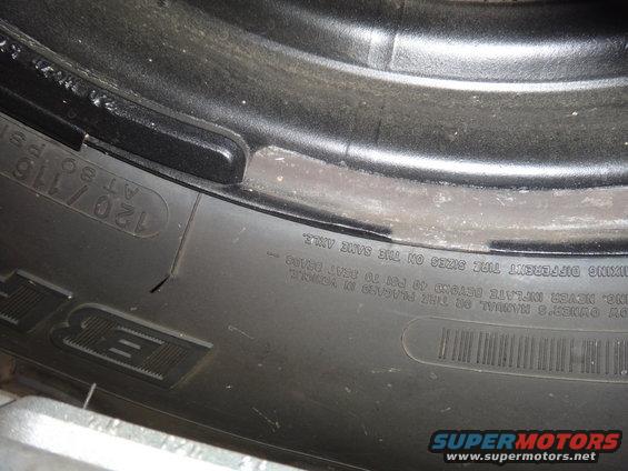 Close-up of tire sidewall showing size 120/116 and inflation warnings