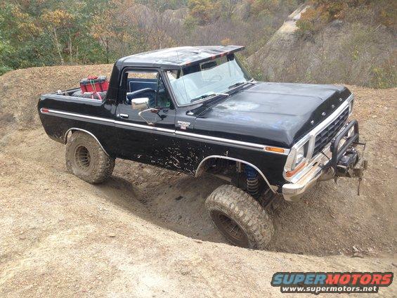 Black 1979 Ford Bronco navigating a dirt trail