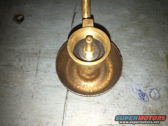 Close-up of a brass fitting with a valve stem inside