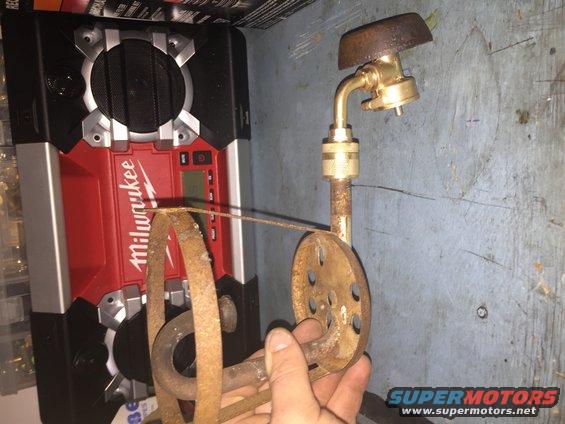 Milwaukee radio next to rusty propane torch attachment
