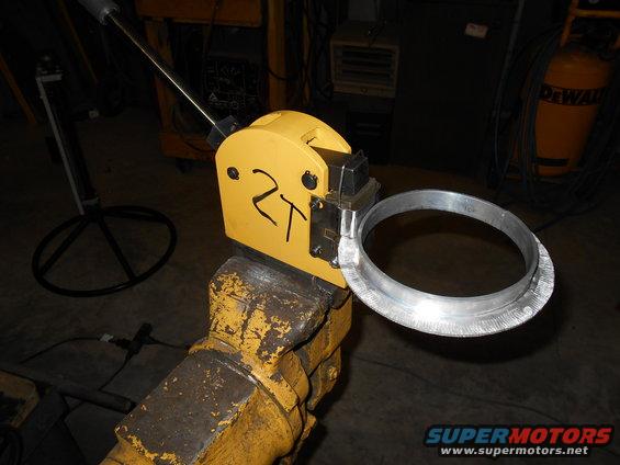 Yellow metal shaping tool with a ring held in a vise