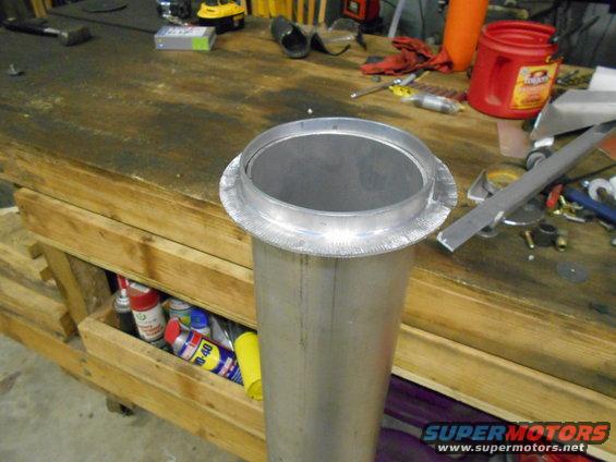 Metal pipe with flanged opening on workbench