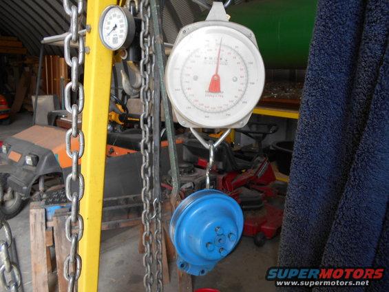 Scale and chains hang in front of a golf cart and lawnmower
