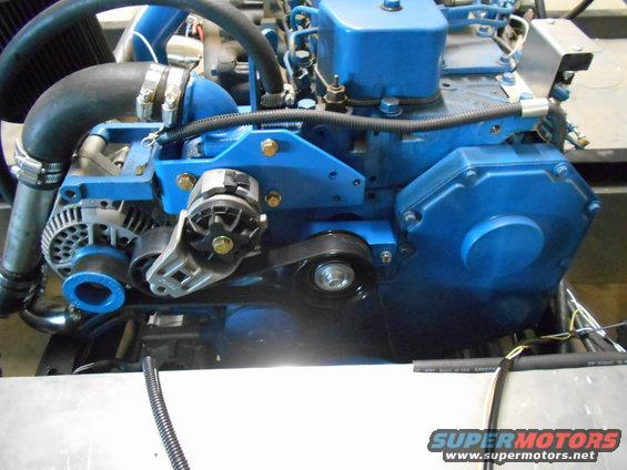 Blue engine with black hoses and silver alternator, close-up view