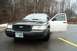 2001 Ford Crown Victoria - Front view of a black 2001 Ford Crown Victoria with the driver's door ajar.