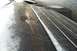 2001 Ford Crown Victoria - A close-up view of a wet car hood with reflections, a tire visible behind it.