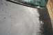 2001 Ford Crown Victoria - The rear of a black vehicle, showing water spots on the trunk and the base of an antenna.