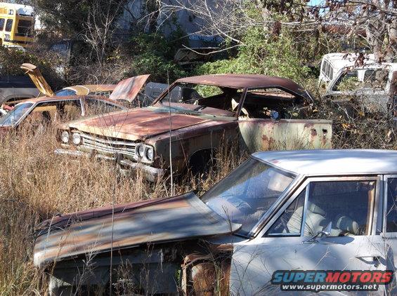 Rusty 1969 Plymouth Road Runner 3q front view in junkyard