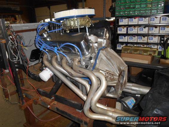 Engine with chrome valve covers and headers on a stand