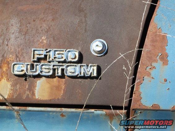 F150 CUSTOM emblem on rusty blue truck door