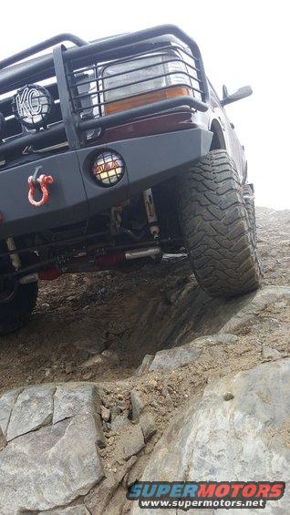 1996 Ford Bronco front bumper with KC lights and tow hook, tire on rocks