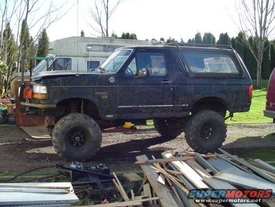 Dark blue 1993 Ford Bronco with large tires and lifted suspension