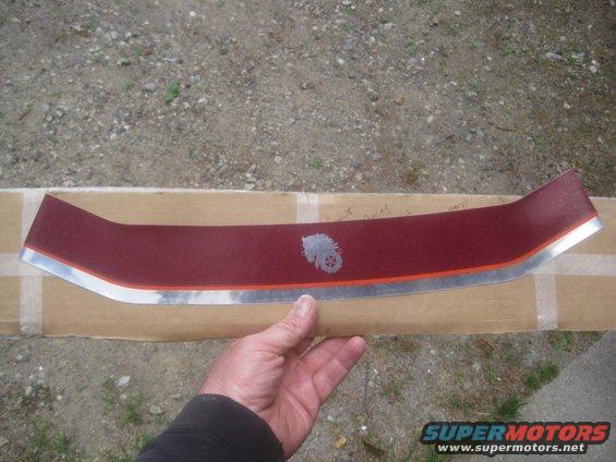 Red trim piece with silver horse logo and orange stripe