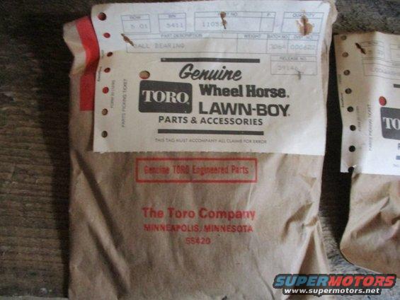 Two brown paper packages with Toro Wheel Horse Lawn-Boy parts and accessories labels. One label says "Genuine Toro Engineered Parts"