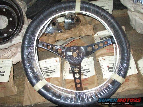 Chrome steering wheel with black grip, wrapped in plastic, with "Genuine Wheel Horse Lawn-Boy Accessories" packaging