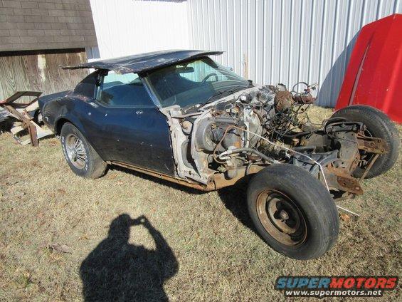 Dark blue 1976 Chevrolet Corvette with front end removed, sitting outside