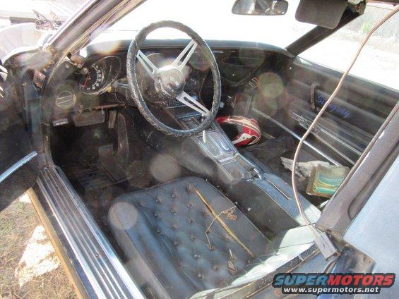 1976 Chevrolet Corvette interior with cracked dashboard and torn seats