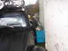 1964 Volkswagen Beetle - Vehicle with roof rack and auxiliary lights parked next to storage bins.