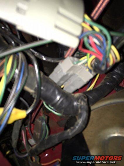 close-up of a tangled vehicle wiring harness with multiple colored wires and connectors