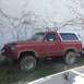 1995 Ford Bronco - This red Ford Bronco with a white top appears to be from the early 1980s, not a 1995 model.