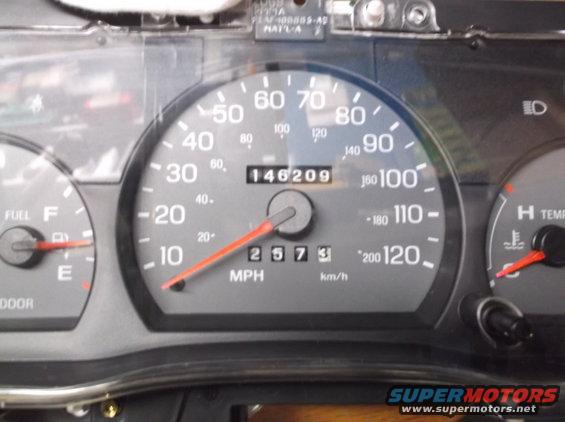 Dashboard gauges with speedometer reading 25 mph and odometer showing 146209 miles