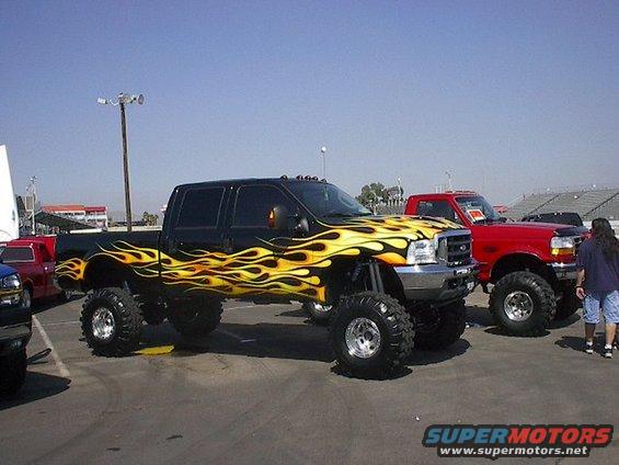 Black pickup truck with yellow flames and lifted suspension